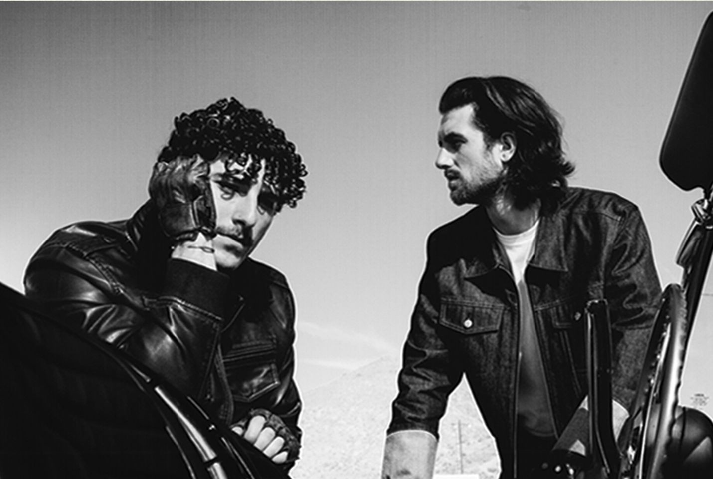 two men posing in black and white